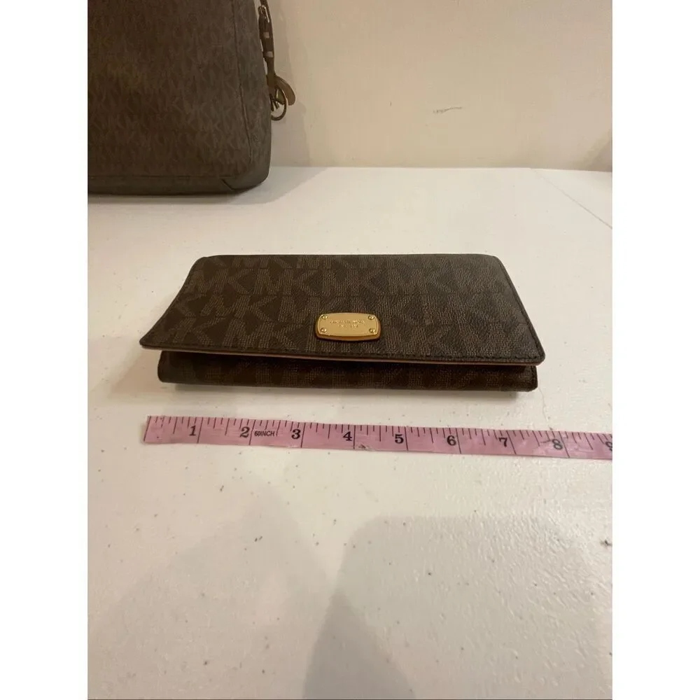 a Michael Kors Jet Set Travel Large Messenger Bag, featuring the brand's signatu